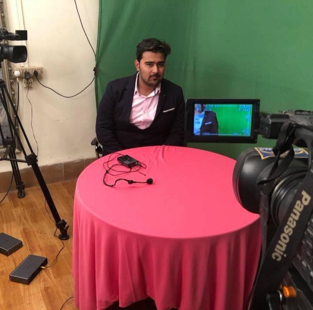 Ali in a television studio interview