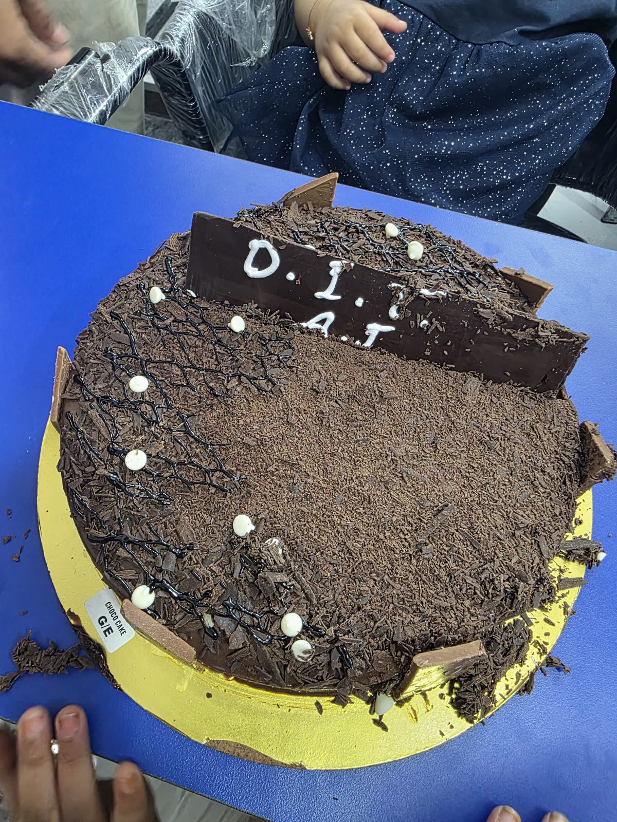 Chocolate cake with a DIT AI topper at the Andheri opening