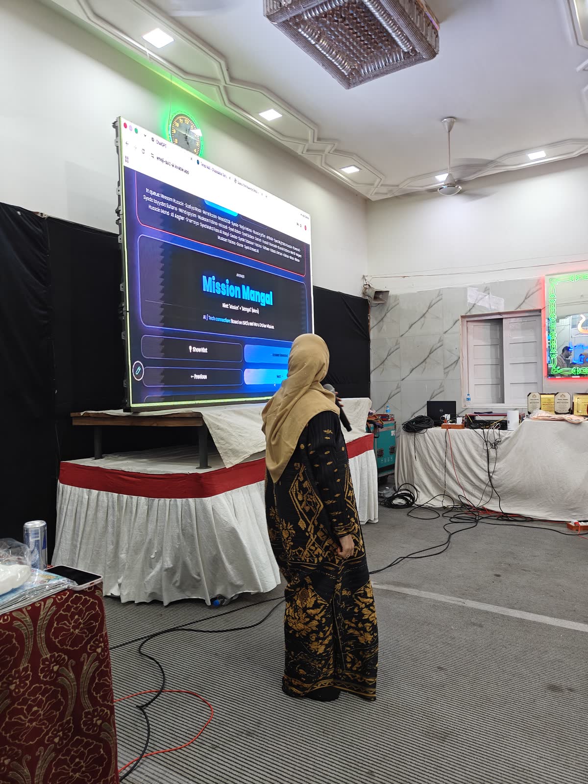 A participant presenting her work on the big screen