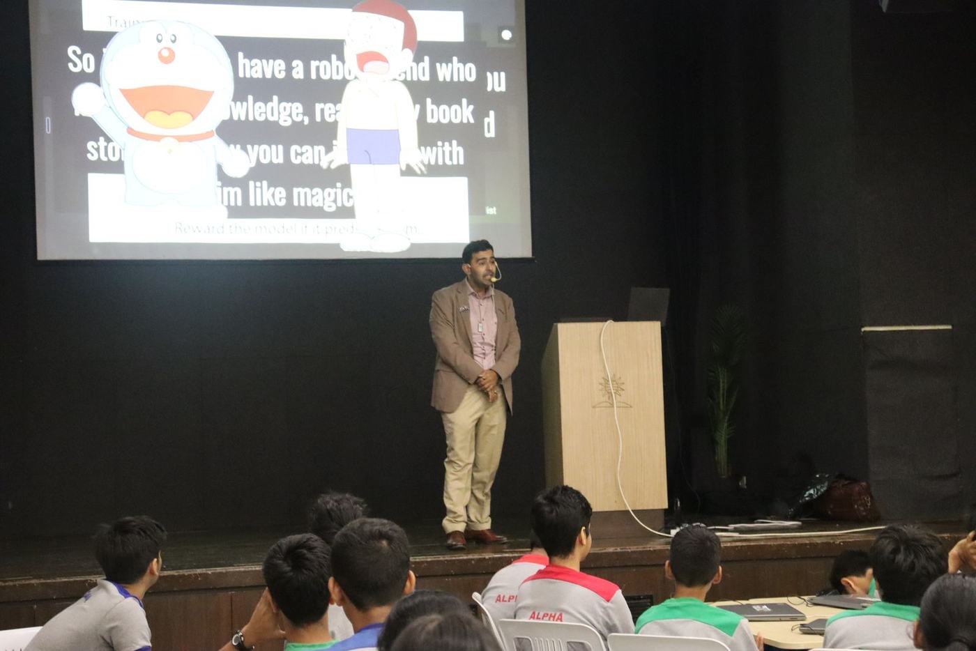 Ali explaining AI with a Doraemon slide