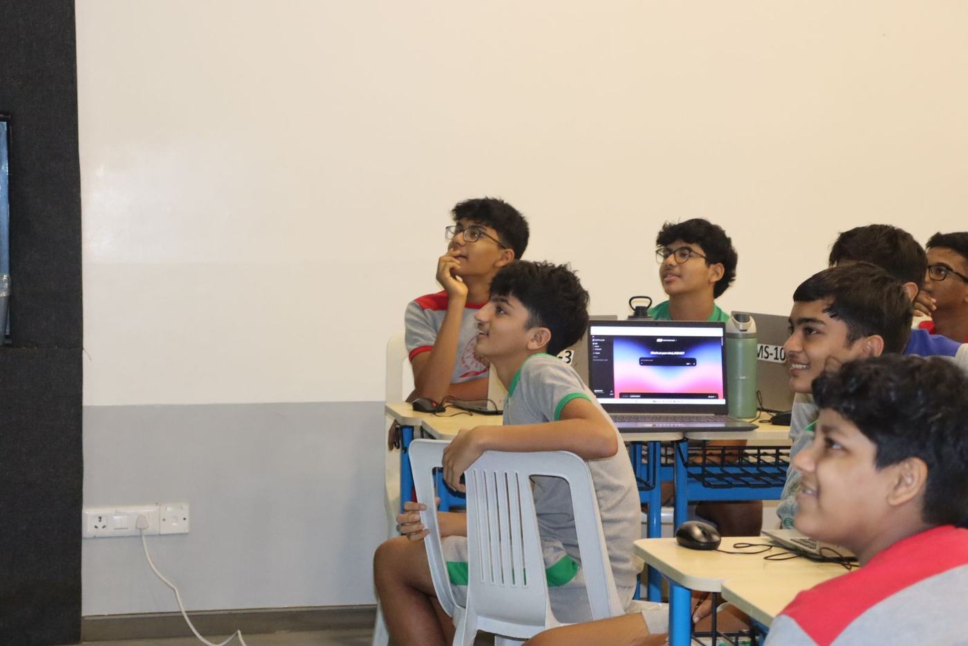 Students grinning at the screen