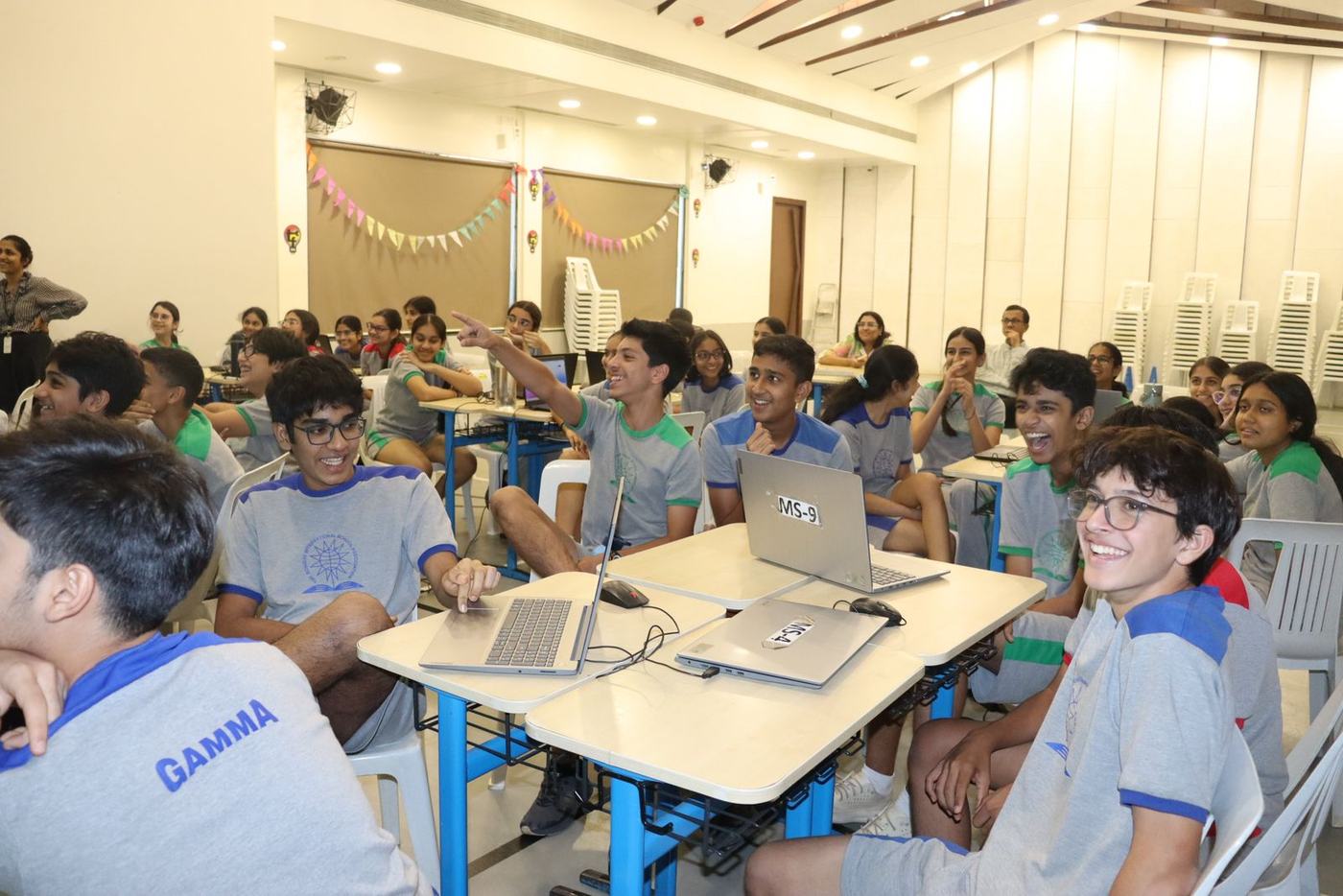 Students cracking up as one points at the screen