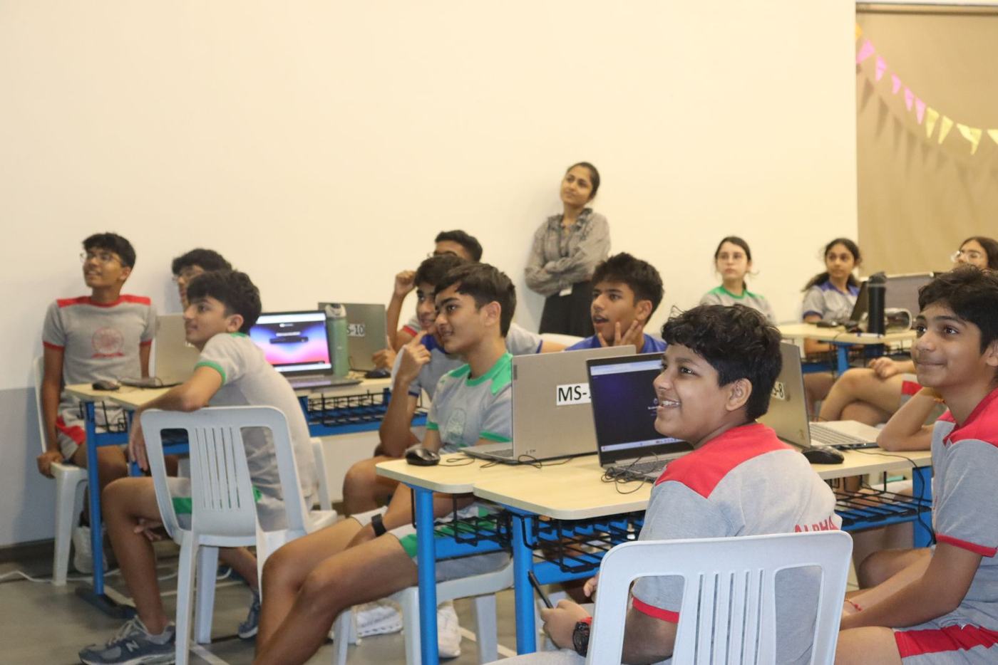 Students smiling as the next demo starts