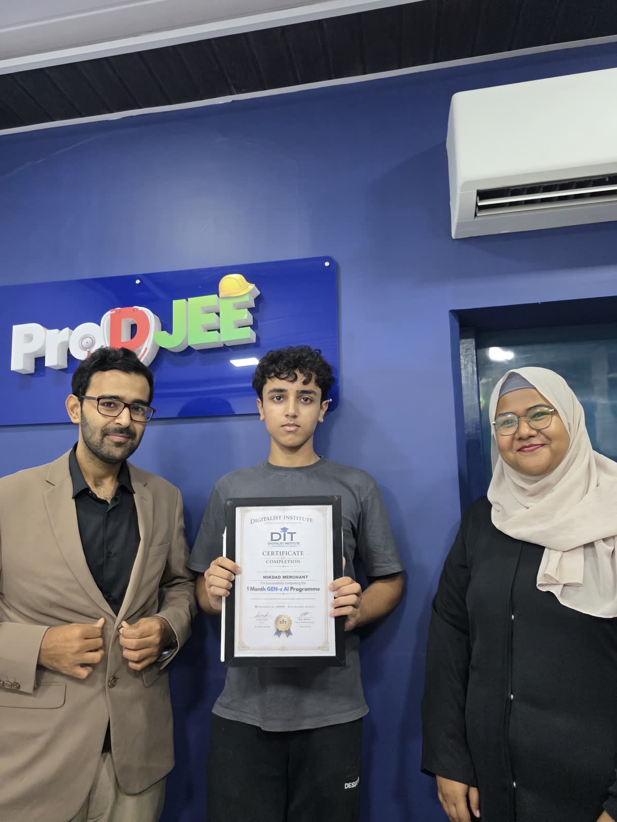 A graduate receiving a framed certificate from Ali