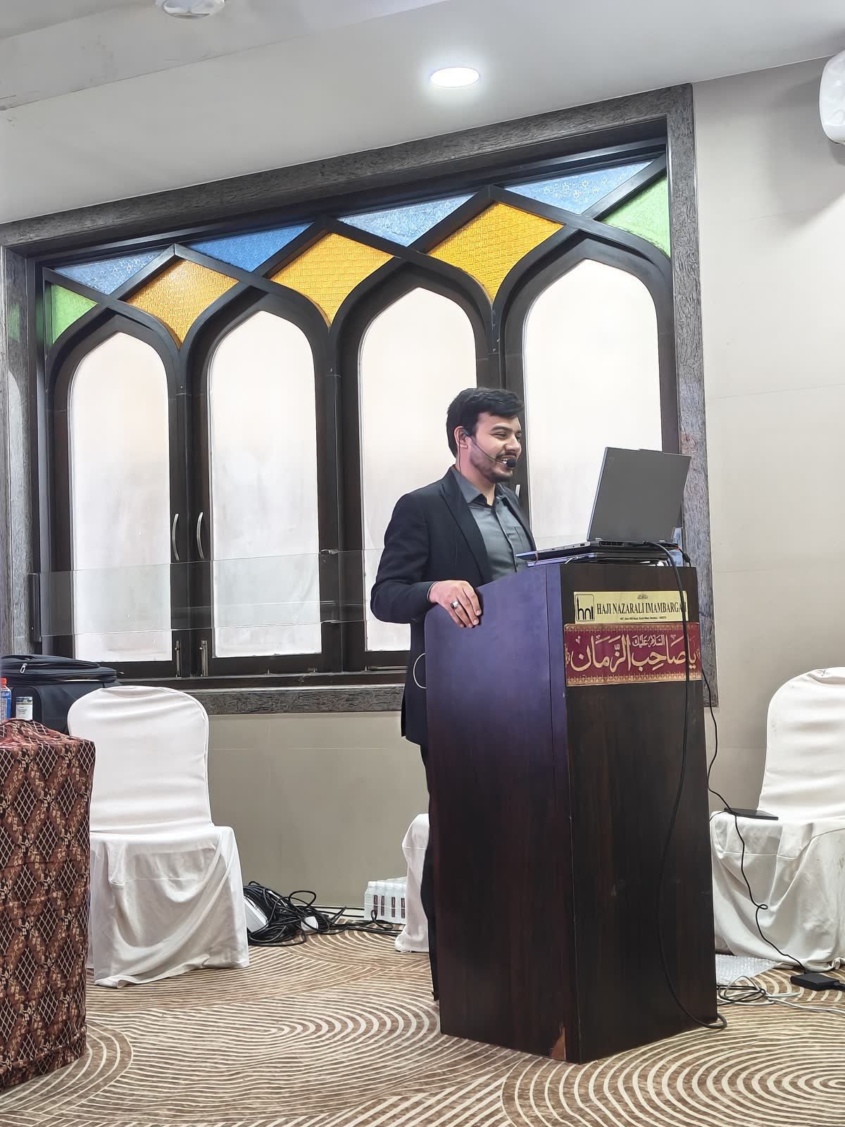 Ali at the lectern in Kurla