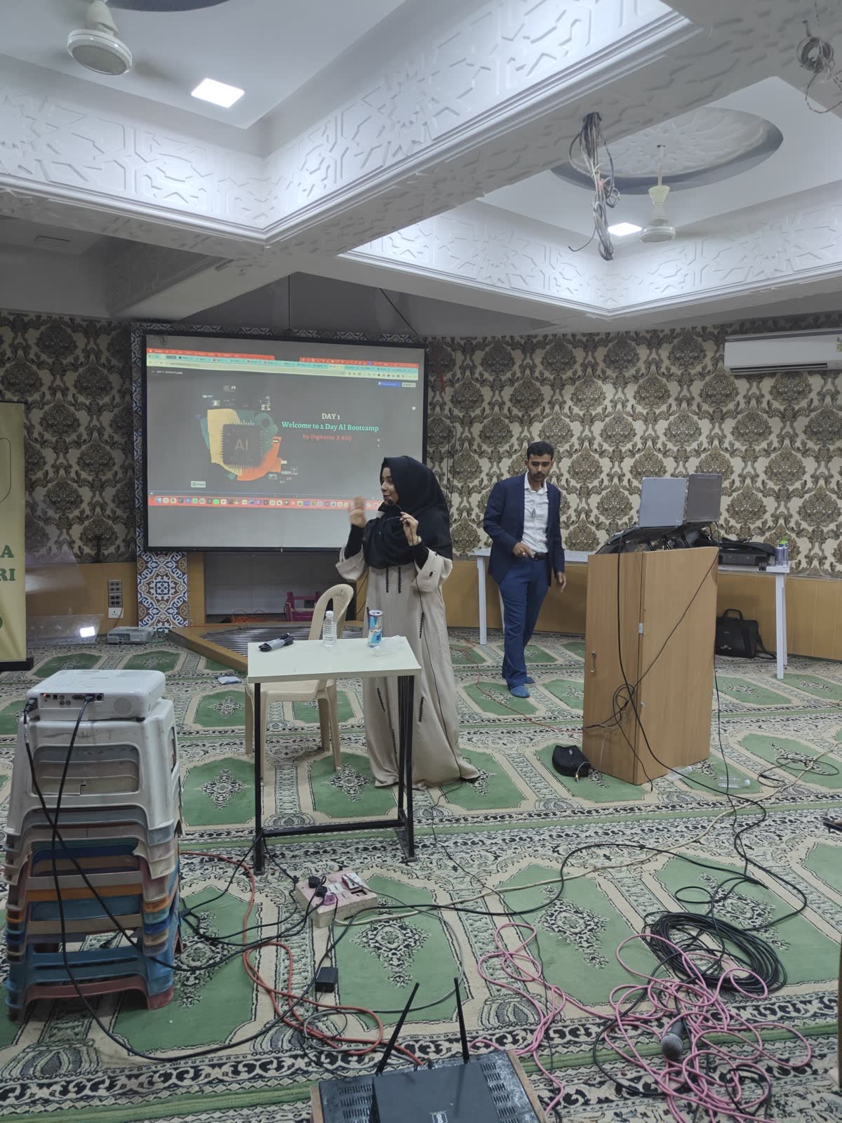 A participant presenting her work at the front of the room