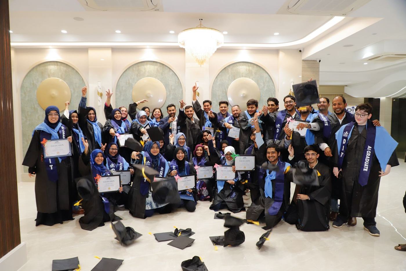 The whole batch in gowns after throwing their caps