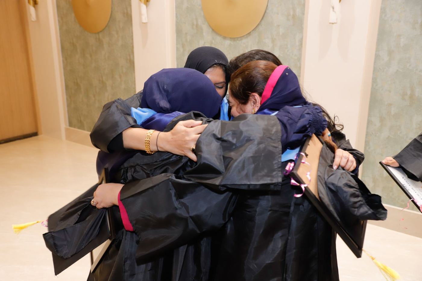 Two graduates hugging after the ceremony