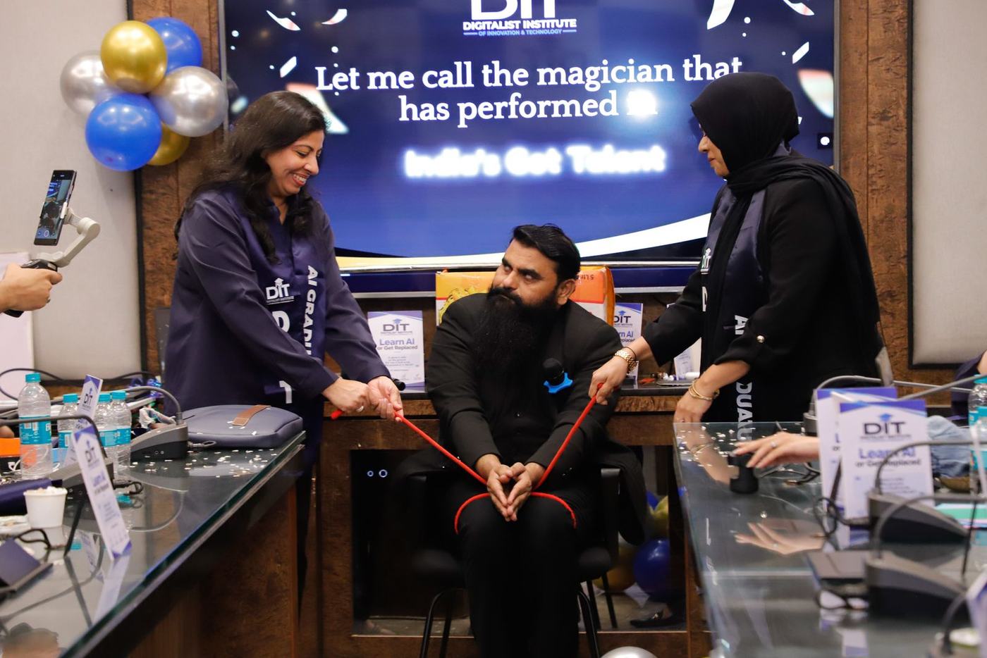 The magician performs a rope trick with a graduate