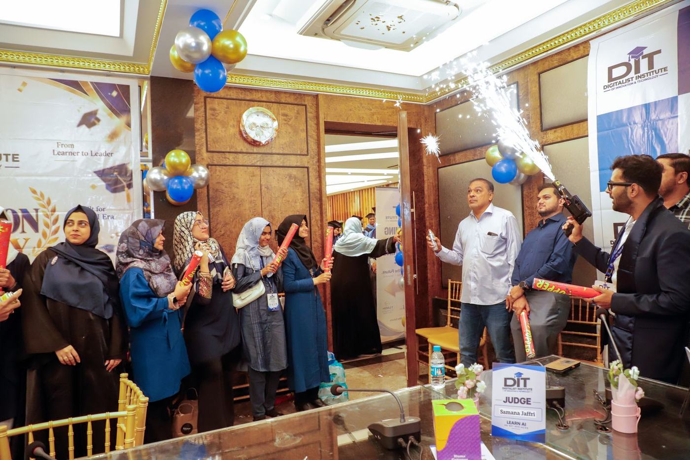 Ali celebrating with graduates under sparklers