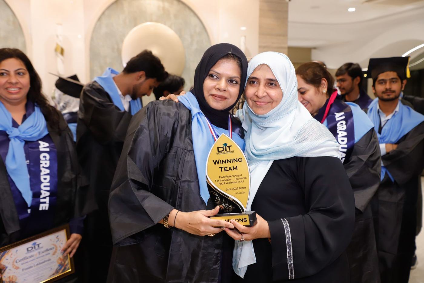 Graduates with their trophies
